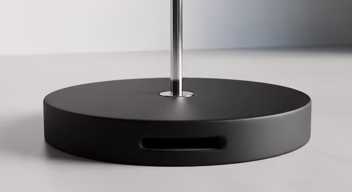 A thick, round crash mat placed securely around the base of a home fitness pole.